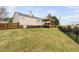 Enjoy a backyard with a wooden deck and pergola, fenced-in for privacy, with a lush lawn at 1202 Lexington Ridge Ln, Apex, NC 27502