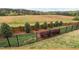 Fenced backyard with a combination of wood and metal fencing, complemented by landscaping and wooded views at 1202 Lexington Ridge Ln, Apex, NC 27502