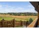 Backyard view from the deck with a partial wood fence and metal fence showcasing the serene, wooded surroundings at 1202 Lexington Ridge Ln, Apex, NC 27502