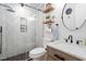 Modern bathroom with a glass shower, wood shelves, marble sink, and hexagon tile flooring at 1202 Lexington Ridge Ln, Apex, NC 27502