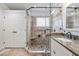 Elegant bathroom featuring a walk-in glass shower with pebble floor and granite countertops at 1202 Lexington Ridge Ln, Apex, NC 27502