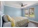 Cozy bedroom with hardwood floors, ceiling fan, and natural light at 1202 Lexington Ridge Ln, Apex, NC 27502