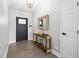 Welcoming entryway with wood floors, console table, modern mirror, and neutral paint at 1202 Lexington Ridge Ln, Apex, NC 27502