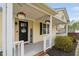 Inviting front porch with decorative wreath, planters, and charming welcome sign at 1202 Lexington Ridge Ln, Apex, NC 27502
