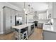 Spacious kitchen featuring gray and white cabinets, stainless appliances, and a central island at 1202 Lexington Ridge Ln, Apex, NC 27502