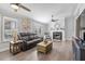 Bright living room with hardwood floors, a fireplace, ceiling fans, and comfortable seating at 1202 Lexington Ridge Ln, Apex, NC 27502