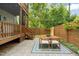 Outdoor brick patio featuring a dining set and stairs leading to a multi-story deck at 1202 S Bloodworth St, Raleigh, NC 27601