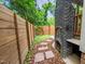 Exterior of backyard featuring a brick fireplace, stone walkway, and privacy fence at 1202 S Bloodworth St, Raleigh, NC 27601