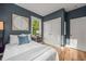 Comfortable bedroom featuring closet space, natural lighting, and hardwood floors at 1202 S Bloodworth St, Raleigh, NC 27601