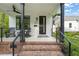 Inviting front porch with brick steps and black metal railings at 1202 S Bloodworth St, Raleigh, NC 27601