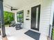 Inviting front porch with rocking chairs, stylish lighting, and black trim at 1202 S Bloodworth St, Raleigh, NC 27601