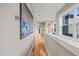 Hallway area featuring hardwood floors, natural lighting, and is decorated with stylish artwork at 1202 S Bloodworth St, Raleigh, NC 27601