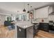Open-concept kitchen with granite countertops, stainless steel appliances, and a view to the dining and living rooms at 1202 S Bloodworth St, Raleigh, NC 27601