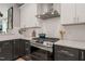 Updated kitchen with stainless steel stove top, white subway tile backsplash, and granite countertops at 1202 S Bloodworth St, Raleigh, NC 27601