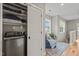 Convenient upstairs laundry area with new washer, storage shelves, and access to the hall seating area at 1202 S Bloodworth St, Raleigh, NC 27601