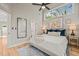 Bright main bedroom with hardwood floors, high ceilings, ceiling fan, and an attached full bathroom at 1202 S Bloodworth St, Raleigh, NC 27601