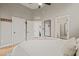Bright main bedroom with hardwood floors, high ceilings, ceiling fan, and multiple closets at 1202 S Bloodworth St, Raleigh, NC 27601