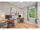 Bright home office featuring two desks, hardwood floors, and a large window at 1202 S Bloodworth St, Raleigh, NC 27601