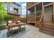 Outdoor brick patio featuring an outdoor dining set, string lights, and a wooden privacy fence at 1202 S Bloodworth St, Raleigh, NC 27601