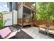 Multi-story back porch and patio with outdoor dining and a lounge chair on a stone path at 1202 S Bloodworth St, Raleigh, NC 27601