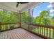 Relaxing screened-in porch offering scenic views of surrounding lush green trees and blue skies at 1202 S Bloodworth St, Raleigh, NC 27601