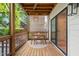 Charming covered porch with outdoor seating, wooden floors, and soft lighting, perfect for entertaining at 1202 S Bloodworth St, Raleigh, NC 27601