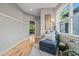 This sitting area has natural light and views of the outdoors with a side table and leafy green plant at 1202 S Bloodworth St, Raleigh, NC 27601