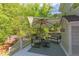 This back deck shows patio furniture and an umbrella to help enjoy time outside at 1311 Antler Point Dr, Durham, NC 27713