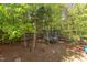 A backyard featuring mature trees and a trampoline at 1311 Antler Point Dr, Durham, NC 27713