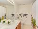 Bright bathroom with double sink vanity, neutral tile floor, and playful world map wall decor at 1311 Antler Point Dr, Durham, NC 27713