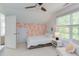 Attic bedroom features fun wallpaper, a ceiling fan, bright light and eclectic art at 1311 Antler Point Dr, Durham, NC 27713