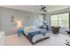 Comfortable bedroom with a ceiling fan, two chairs by window and neutral decor at 1311 Antler Point Dr, Durham, NC 27713