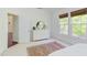 Bright bedroom featuring a white dresser, large windows, and plush carpeting at 1311 Antler Point Dr, Durham, NC 27713