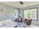 Bright bedroom featuring two cozy chairs, a ceiling fan, and ample natural light at 1311 Antler Point Dr, Durham, NC 27713