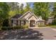 A brick clubhouse building with a tan trim and mature landscaping at 1311 Antler Point Dr, Durham, NC 27713