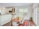 Charming dining area adjacent to the kitchen, featuring hardwood floors and a large window at 1311 Antler Point Dr, Durham, NC 27713