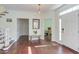 Bright foyer with dark wood floors, white trim, and staircase to the left at 1311 Antler Point Dr, Durham, NC 27713