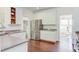 Bright kitchen features white cabinetry, stainless steel appliances, and hardwood floors at 1311 Antler Point Dr, Durham, NC 27713