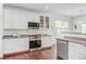 Well-equipped kitchen featuring modern appliances, white cabinets, and a functional layout at 1311 Antler Point Dr, Durham, NC 27713