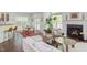 Open concept living room featuring hardwood floors, a fireplace, and bar seating at 1311 Antler Point Dr, Durham, NC 27713