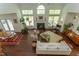 Spacious living room with fireplace, hardwood floors, and ample natural light from large windows at 1311 Antler Point Dr, Durham, NC 27713
