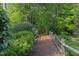 Serene walking path with wooden fence through the woods at 1311 Antler Point Dr, Durham, NC 27713