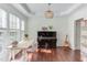 Sunlit study with hardwood floors, large windows, and decorative lighting at 1311 Antler Point Dr, Durham, NC 27713