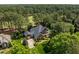 Aerial view of a luxury home with mature trees, golf course and beautiful landscaping at 1317 Colonial Club Rd, Wake Forest, NC 27587