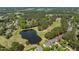 Beautiful aerial view of golf course community featuring lush landscaping and a tranquil pond at 1317 Colonial Club Rd, Wake Forest, NC 27587