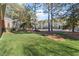 Spacious backyard with mature trees, lush green lawn and serene setting at 1317 Colonial Club Rd, Wake Forest, NC 27587