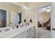Bright bathroom featuring a double sink vanity, large mirror, and access to the bedroom at 1317 Colonial Club Rd, Wake Forest, NC 27587