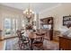 Dining room featuring a large window, chandelier, and classic wood furniture at 1317 Colonial Club Rd, Wake Forest, NC 27587