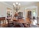Formal dining room featuring an elegant chandelier and classic wood furniture at 1317 Colonial Club Rd, Wake Forest, NC 27587