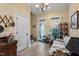 The entryway has a sofa, decoratives, and great natural light from the door and windows at 1317 Colonial Club Rd, Wake Forest, NC 27587